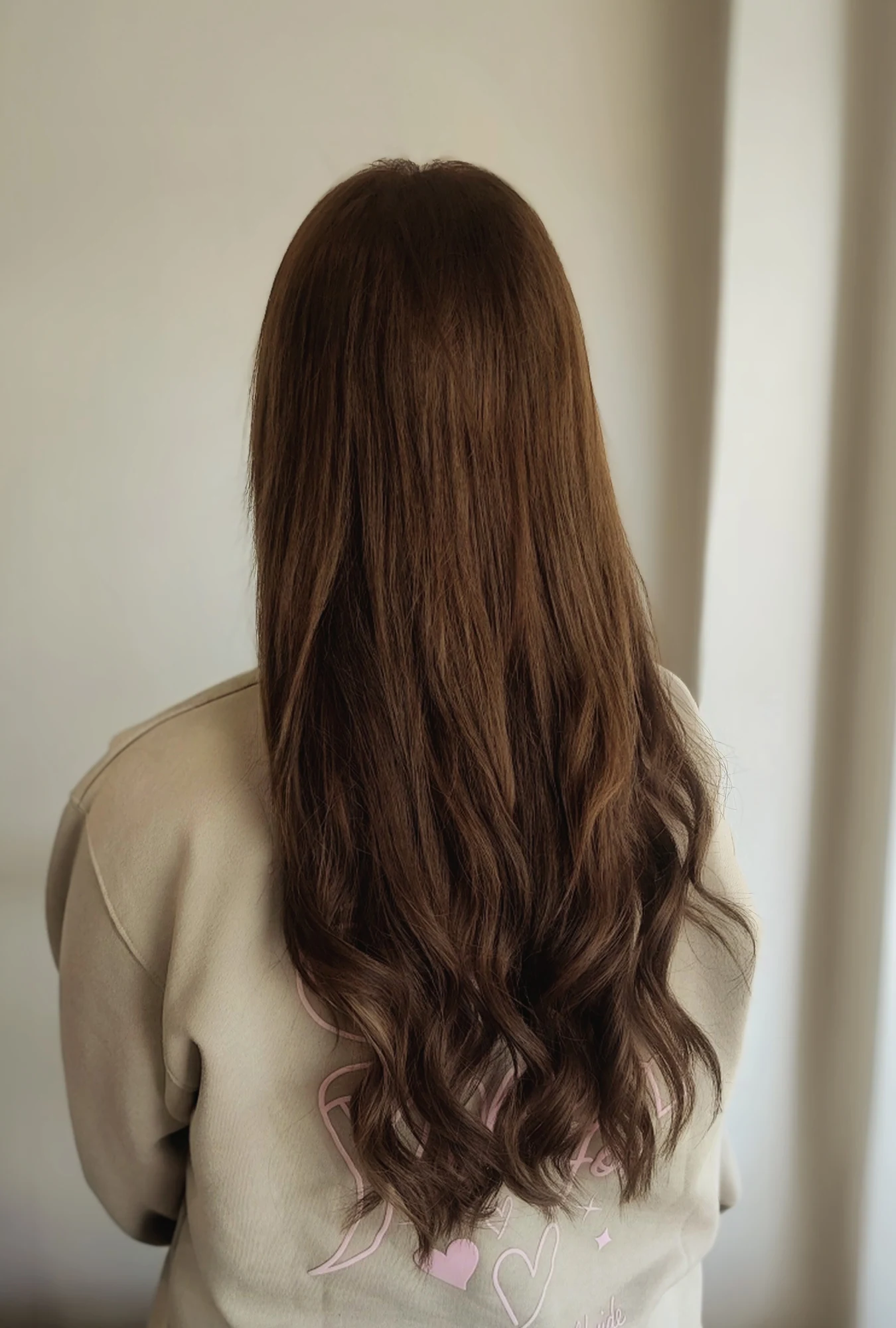 Long, softly waved brunette hair viewed from behind